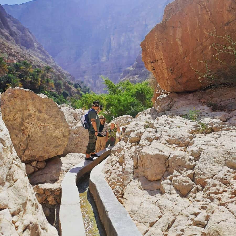 From Muscat: Wadi Shab Expedition - Crossing the water to reach Wadi Shab