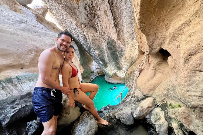 Full Day Wadi Shab And Bimah Sinkhole with Pick Up Included - Crossing the water and walking into the canyon