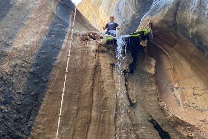 Private Full Day Wadi Dham Tour - Walking across the smooth rocks